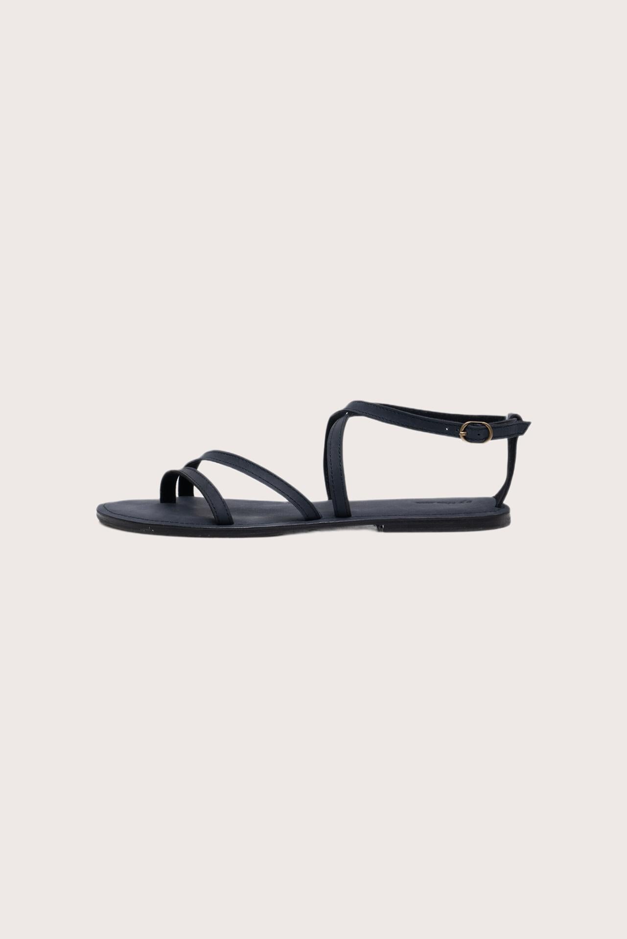 Side profile of Astola sandal in navy highlighting sleek and modern resort footwear silhouette
