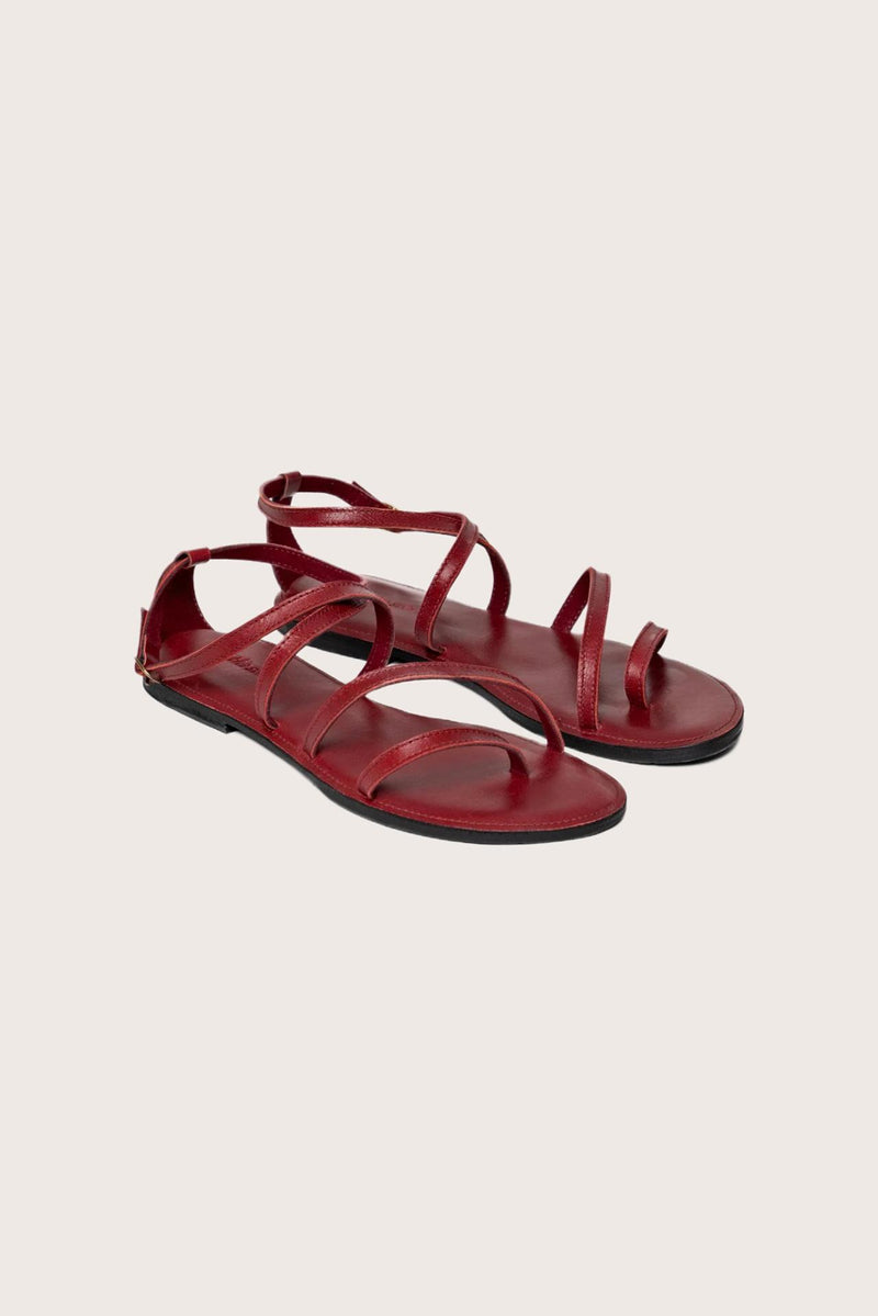 Astola sandal in red front view showcasing elegant straps and minimalist resort aesthetic