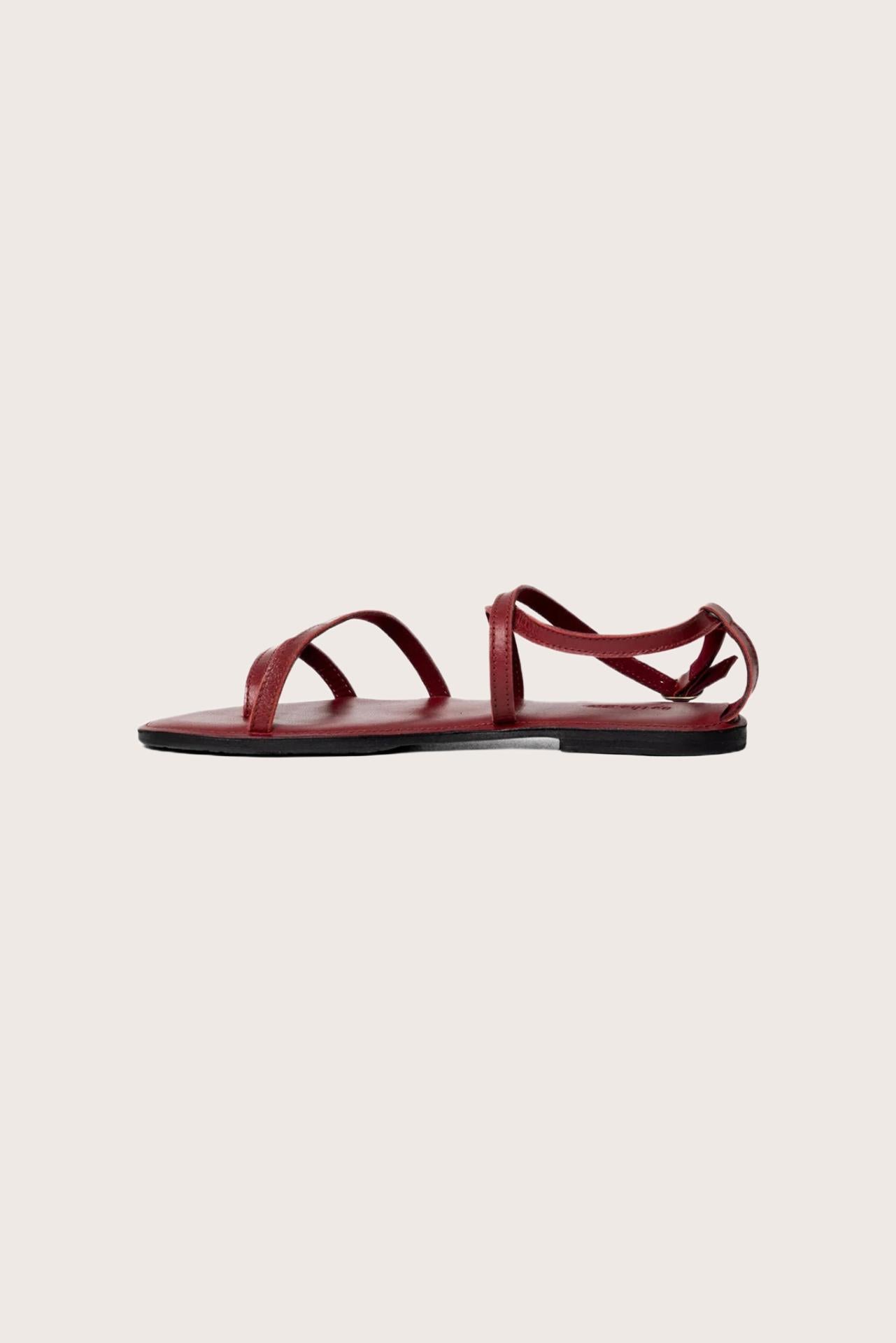 Side profile of Astola sandal in red highlighting sleek and modern resort footwear silhouette