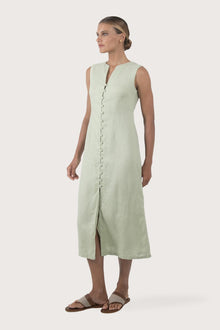 Side profile of the Ayu Linen Maxi Dress Pastel Green showing its cut and natural movement