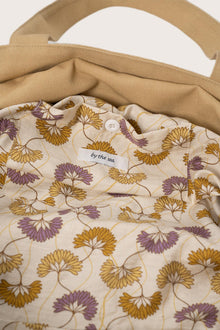 Close-up of the interior lining and stitching details of the creme Barcha tote bag