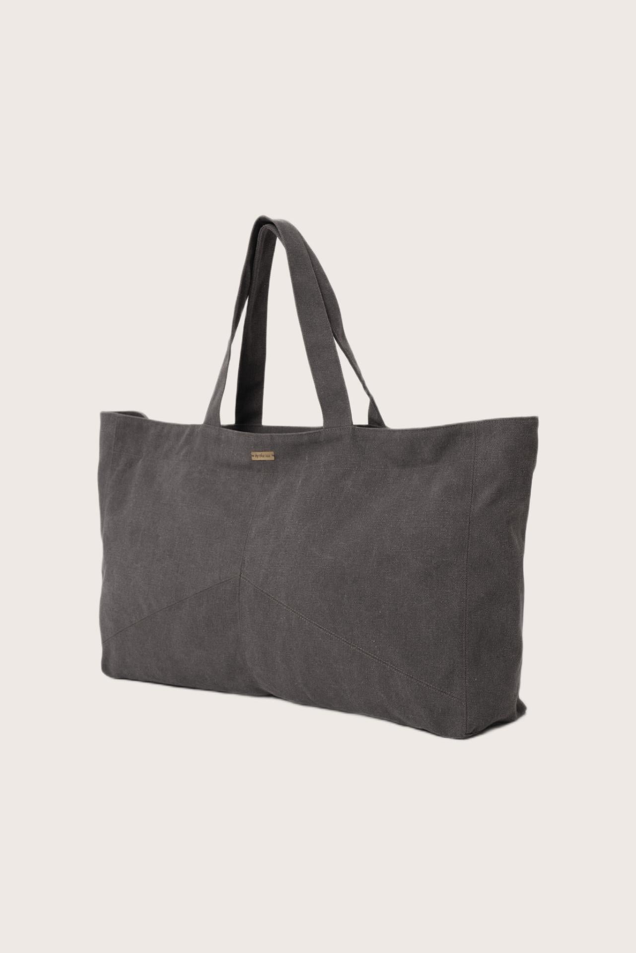 Angled view of the dark brown Barcha tote bag showcasing its spacious design