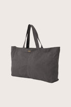 Angled view of the dark brown Barcha tote bag showcasing its spacious design