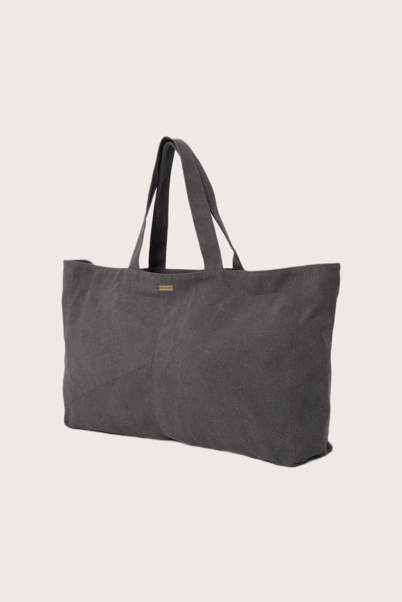 Angled view of the dark brown Barcha tote bag showcasing its spacious design