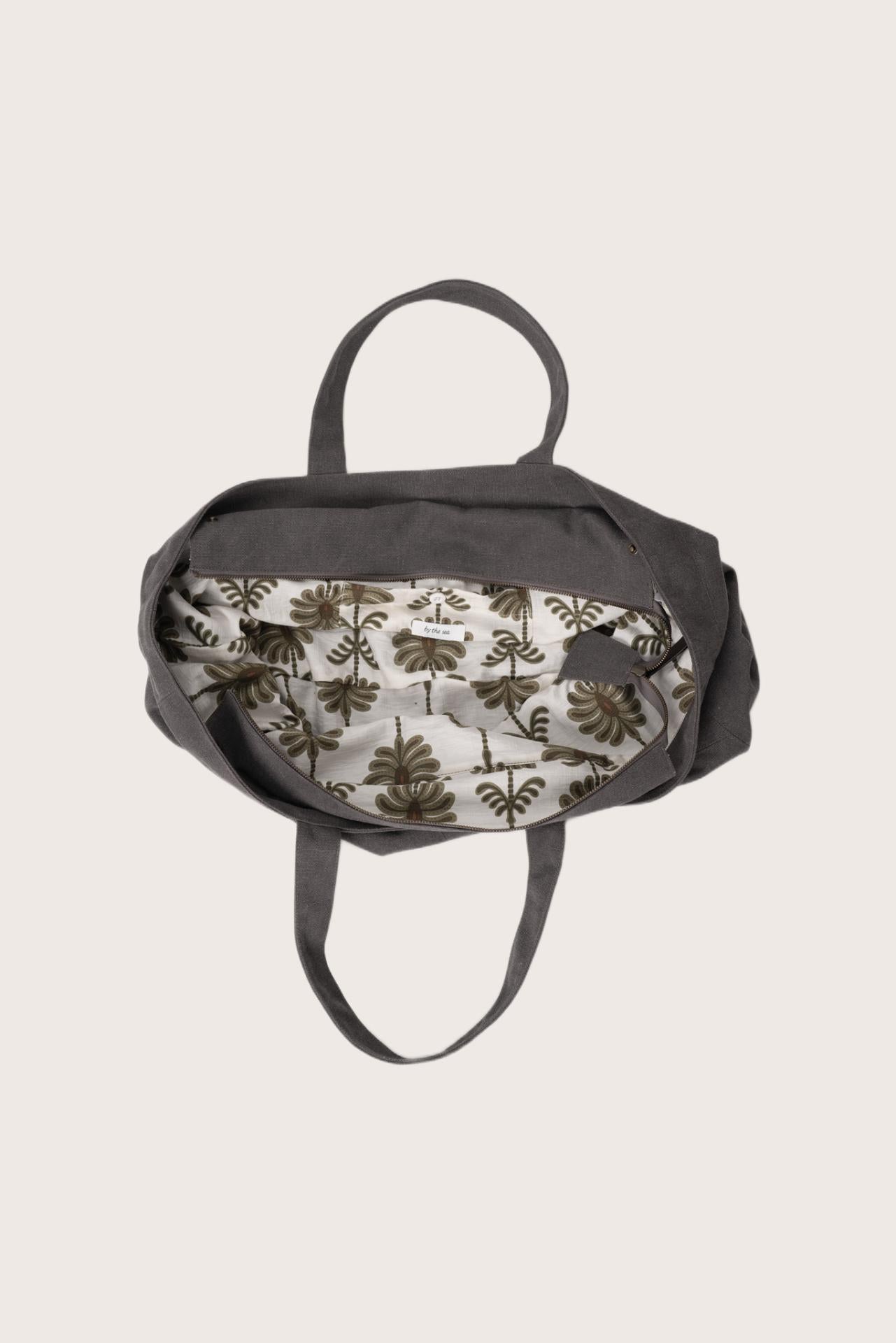 Interior view of the dark brown Barcha tote bag showing the printed lining