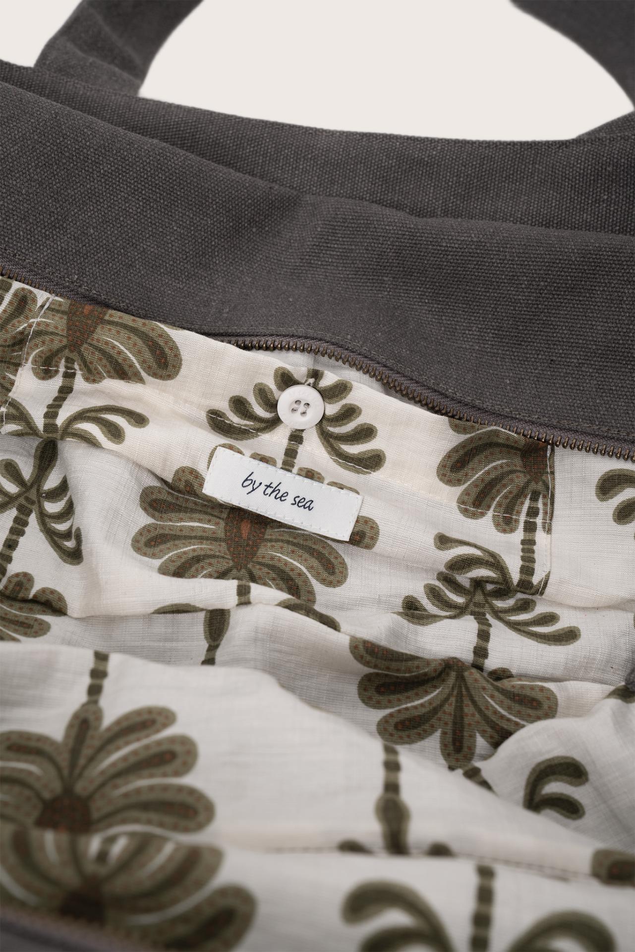 Close-up of the interior lining and stitching details of the dark brown Barcha tote bag