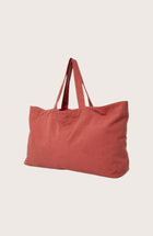 Angled view of the red Barcha tote bag showcasing its spacious design