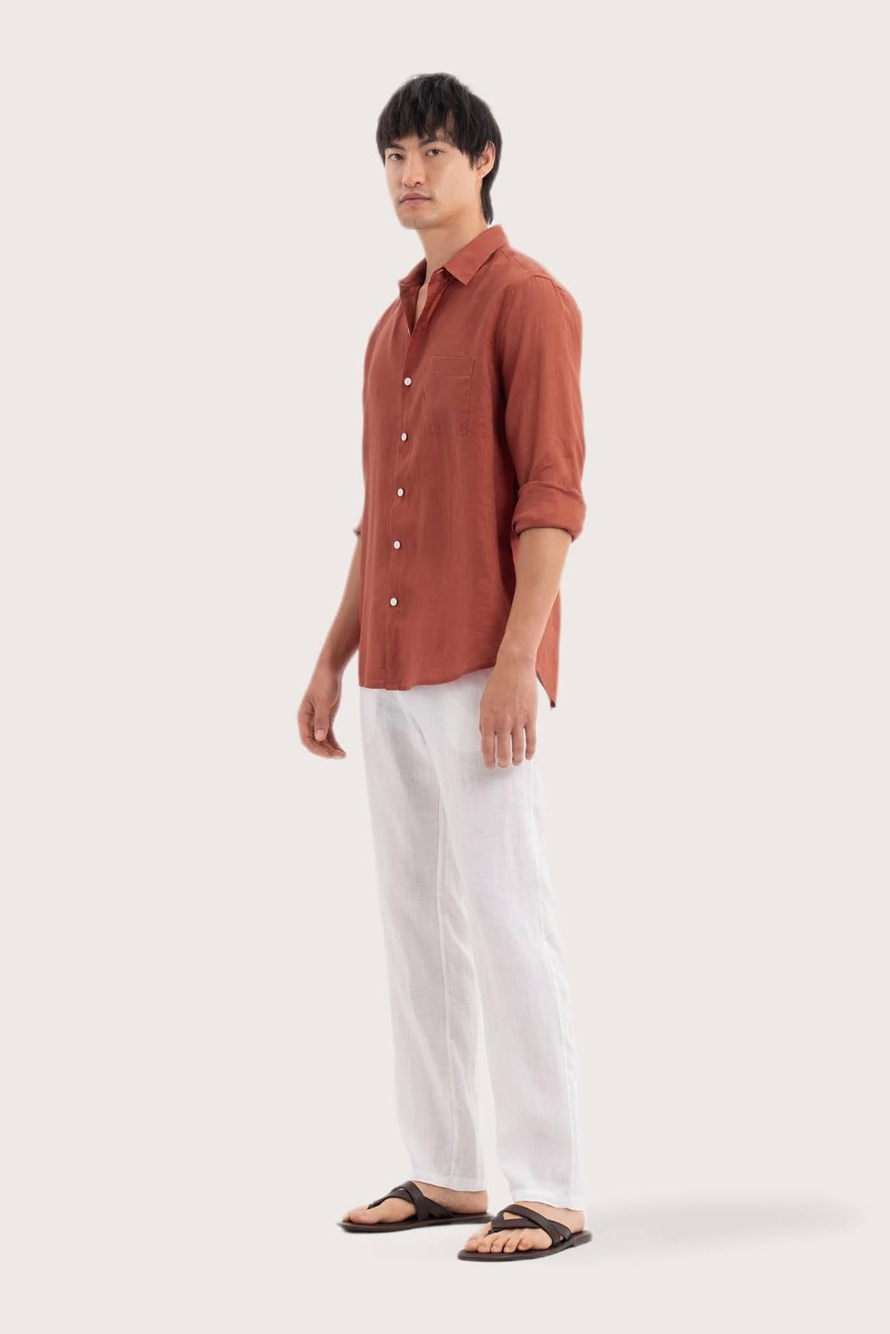 Side profile of the Baron Linen Shirt Brick highlighting its easy, breathable fit by By The Sea Bali