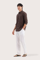Side profile of the Baron Linen Shirt Brown highlighting its easy, breathable fit by By The Sea Bali