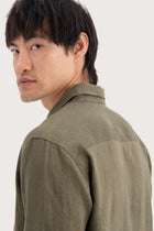 Open collar and button-front detail of the Baron Linen Shirt Green by By The Sea Bali