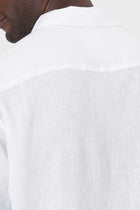 Open collar and button-front detail of the Baron Linen Shirt White by By The Sea Bali