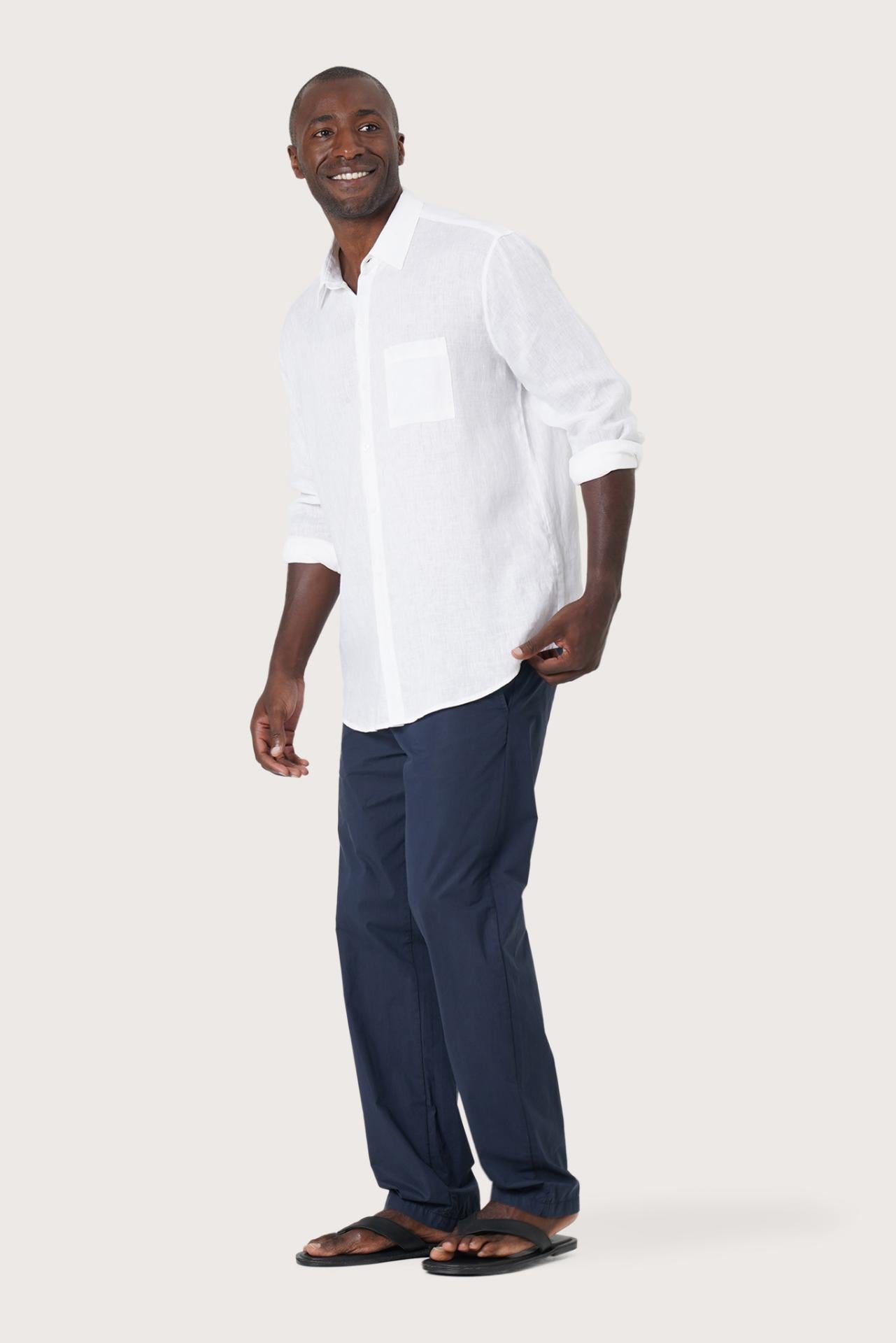 Side profile of the Baron Linen Shirt White highlighting its easy, breathable fit by By The Sea Bali