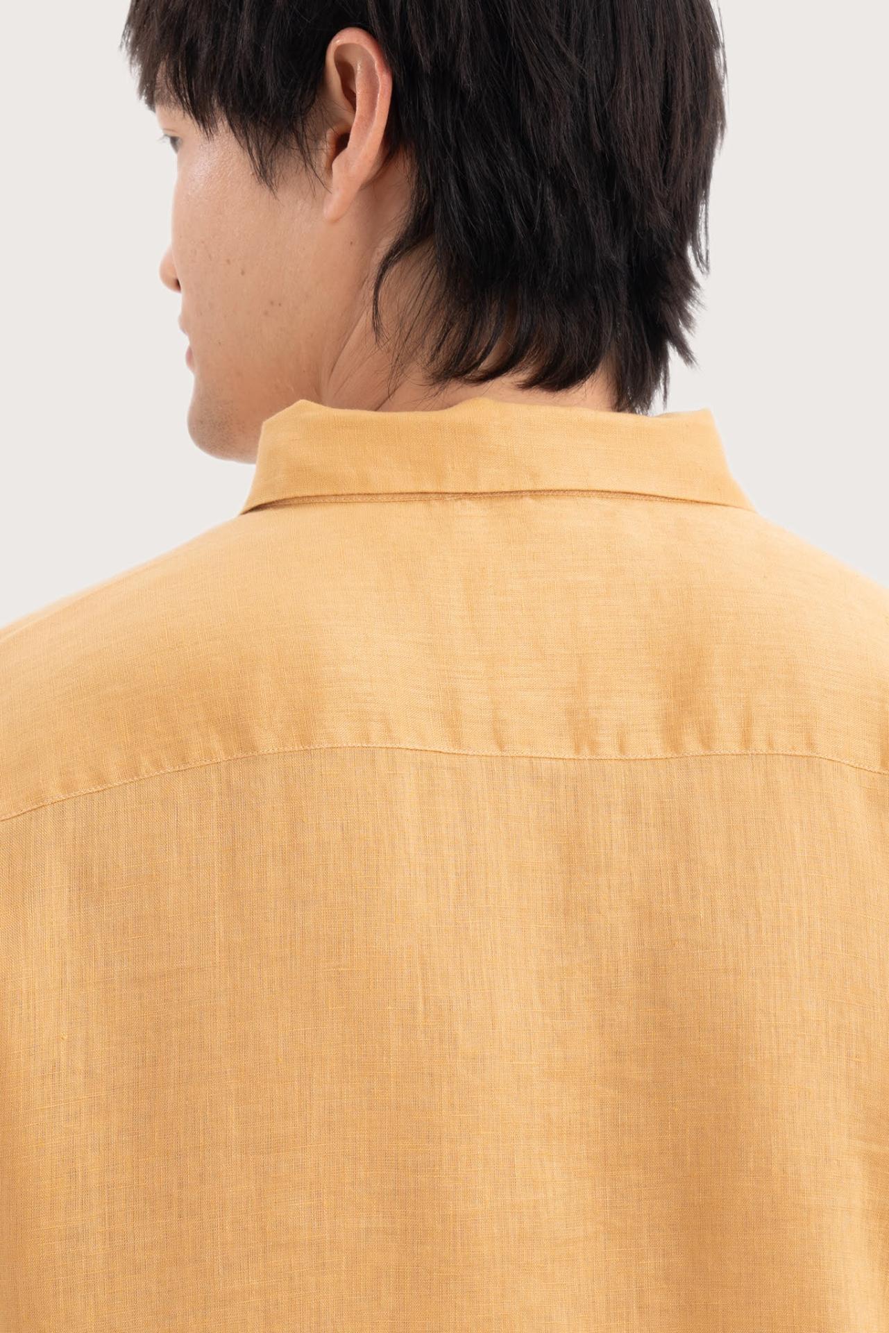 Open collar and button-front detail of the Baron Linen Shirt Yellow by By The Sea Bali