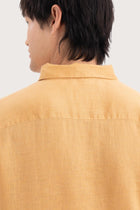 Open collar and button-front detail of the Baron Linen Shirt Yellow by By The Sea Bali