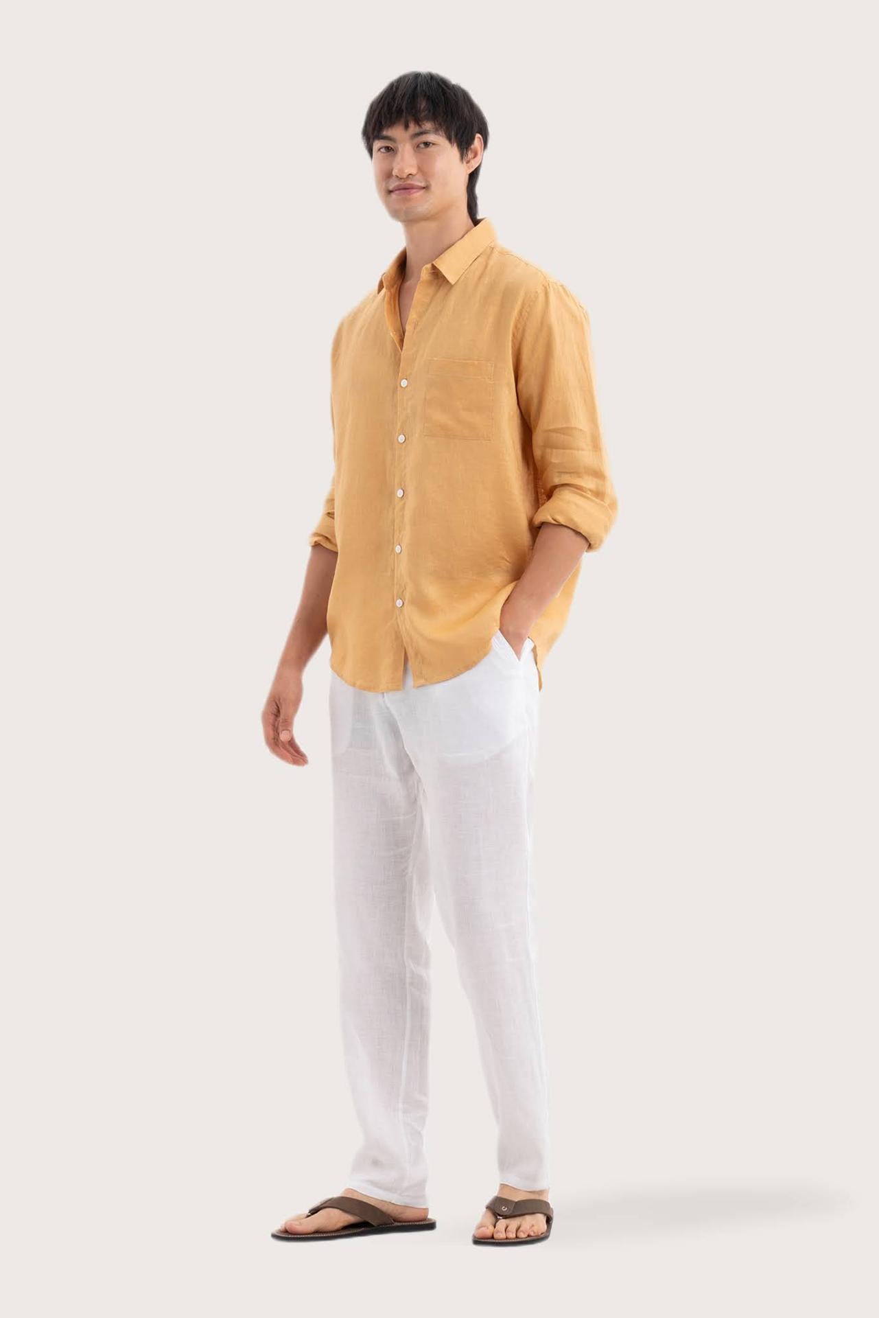 Side profile of the Baron Linen Shirt Yellow highlighting its easy, breathable fit by By The Sea Bali