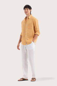 Side profile of the Baron Linen Shirt Yellow highlighting its easy, breathable fit by By The Sea Bali