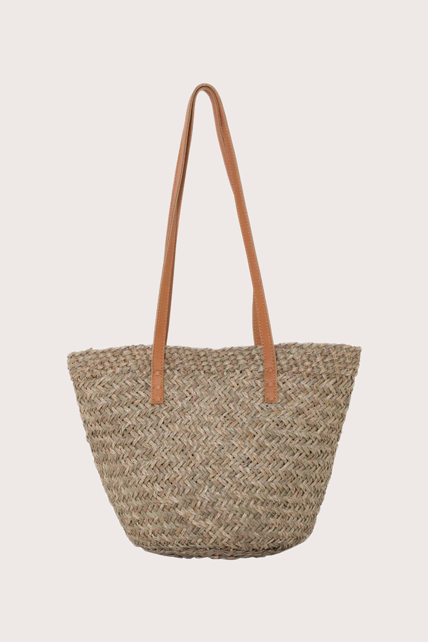 Back view of handcrafted beach bucket straw bag with structured woven silhouette
