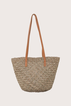 Back view of handcrafted beach bucket straw bag with structured woven silhouette