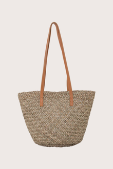 Back view of handcrafted beach bucket straw bag with structured woven silhouette