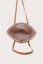 Interior view of beach bucket straw bag showing spacious lined compartment and functional design