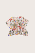 Elegant back view showcasing the flowing silhouette and artistic floral pattern