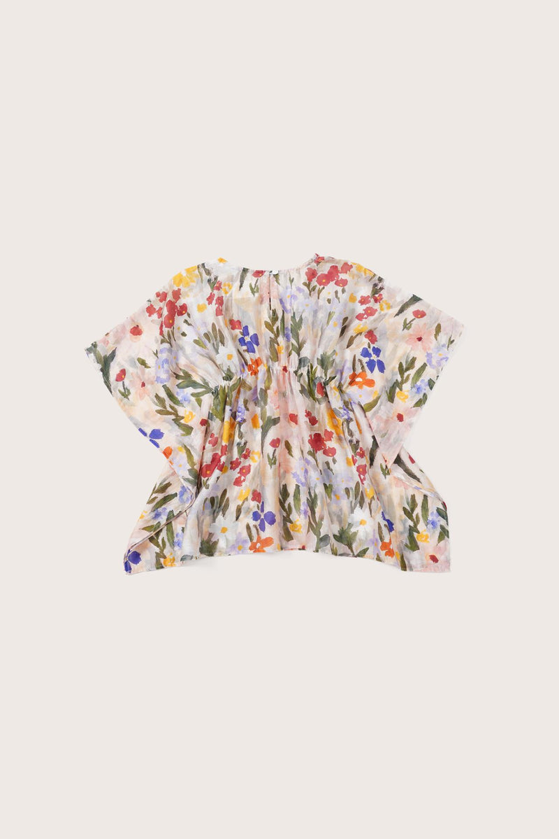 Elegant back view showcasing the flowing silhouette and artistic floral pattern