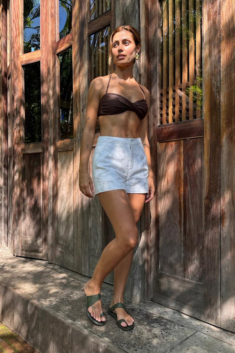 Woman wearing the Besca Linen Short Off White designed for effortless resortwear and tropical living by By The Sea Bali
