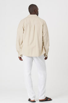 Back view of the cream jacket with a relaxed and contemporary silhouette