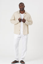 Model wearing the cream Birco jacket by By The Sea Bali
