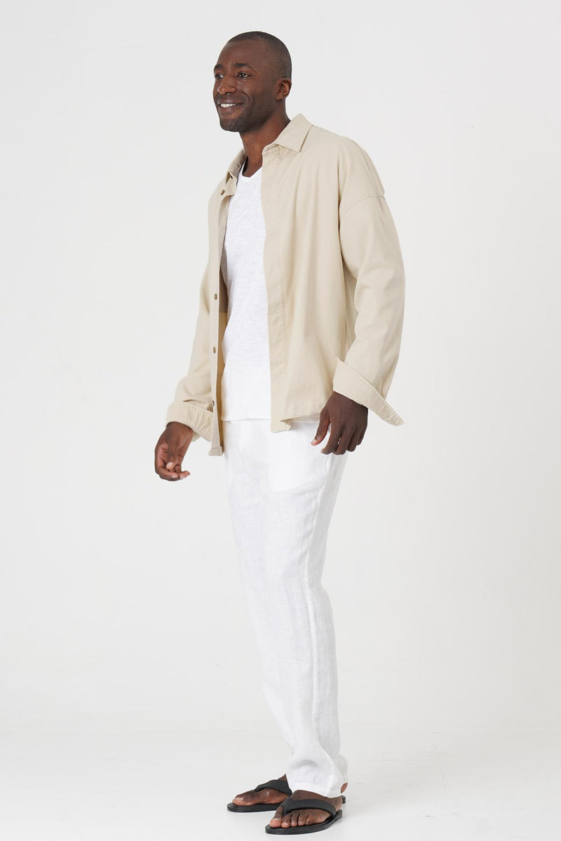 Side profile of the cream jacket showcasing its comfortable fit and clean lines