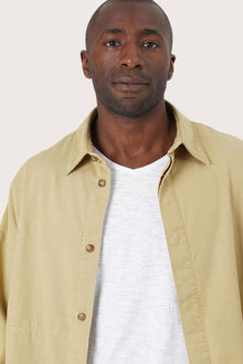 Close-up of the fabric texture and refined jacket detailing in light yellow