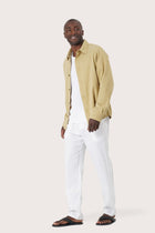 Side profile of the light yellow jacket showcasing its comfortable fit and clean lines