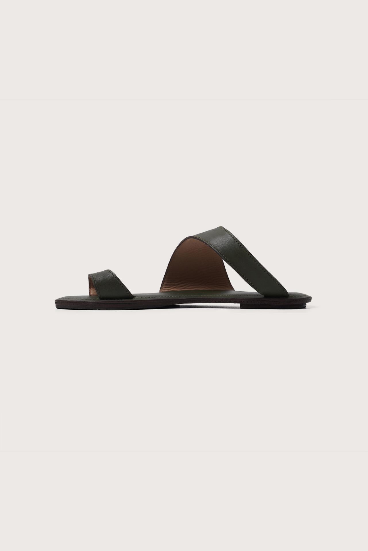 Side profile of Bitsy sandal in green highlighting sleek resort footwear silhouette