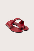 Bitsy sandal in red front view showcasing refined straps and elegant minimalist structure