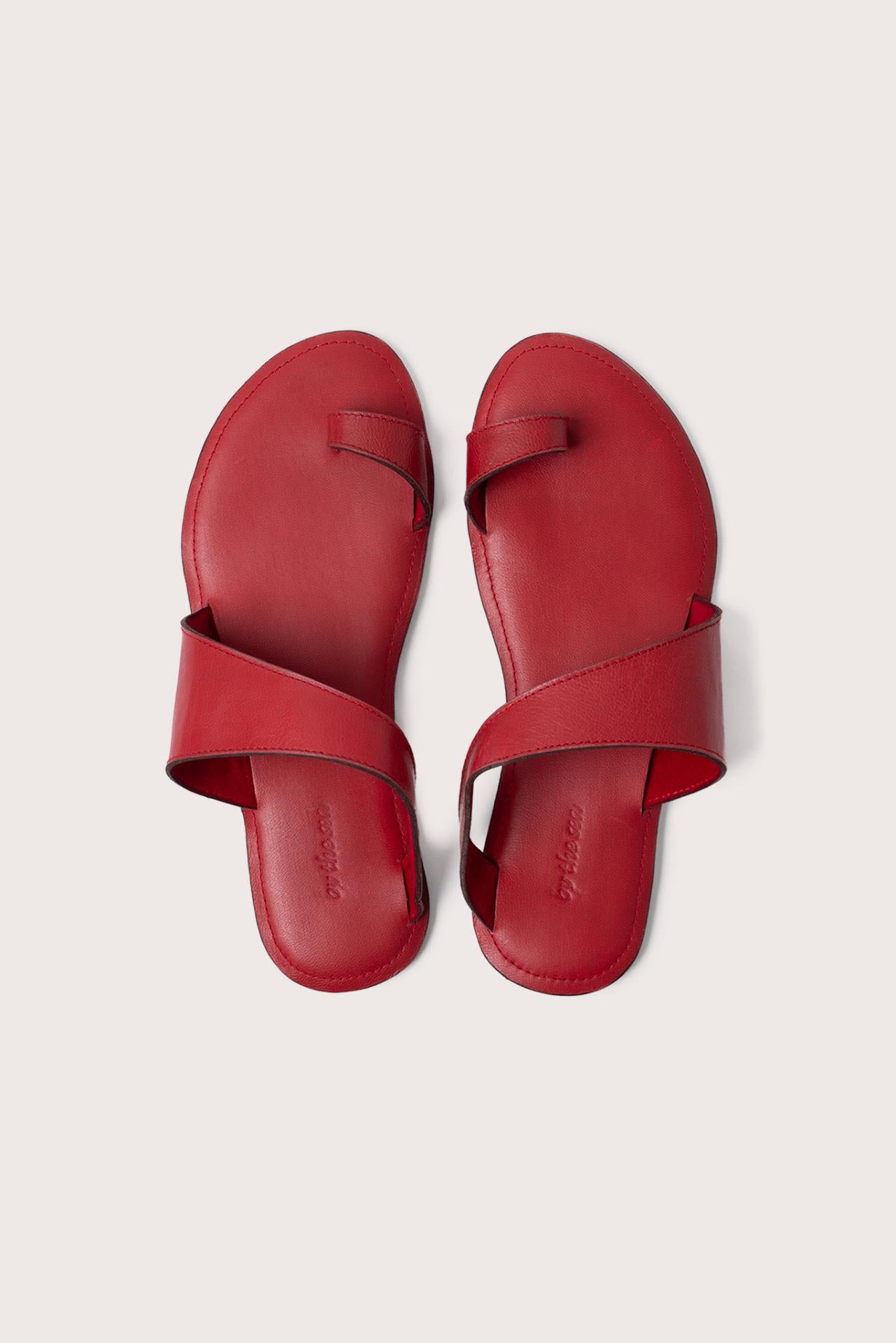 Bitsy sandal in red shown in a global view highlighting its full silhouette and resort-ready design