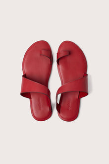 Bitsy sandal in red shown in a global view highlighting its full silhouette and resort-ready design