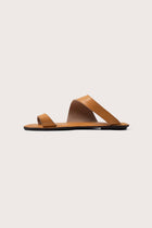Side profile of Bitsy sandal in yellow highlighting sleek resort footwear silhouette