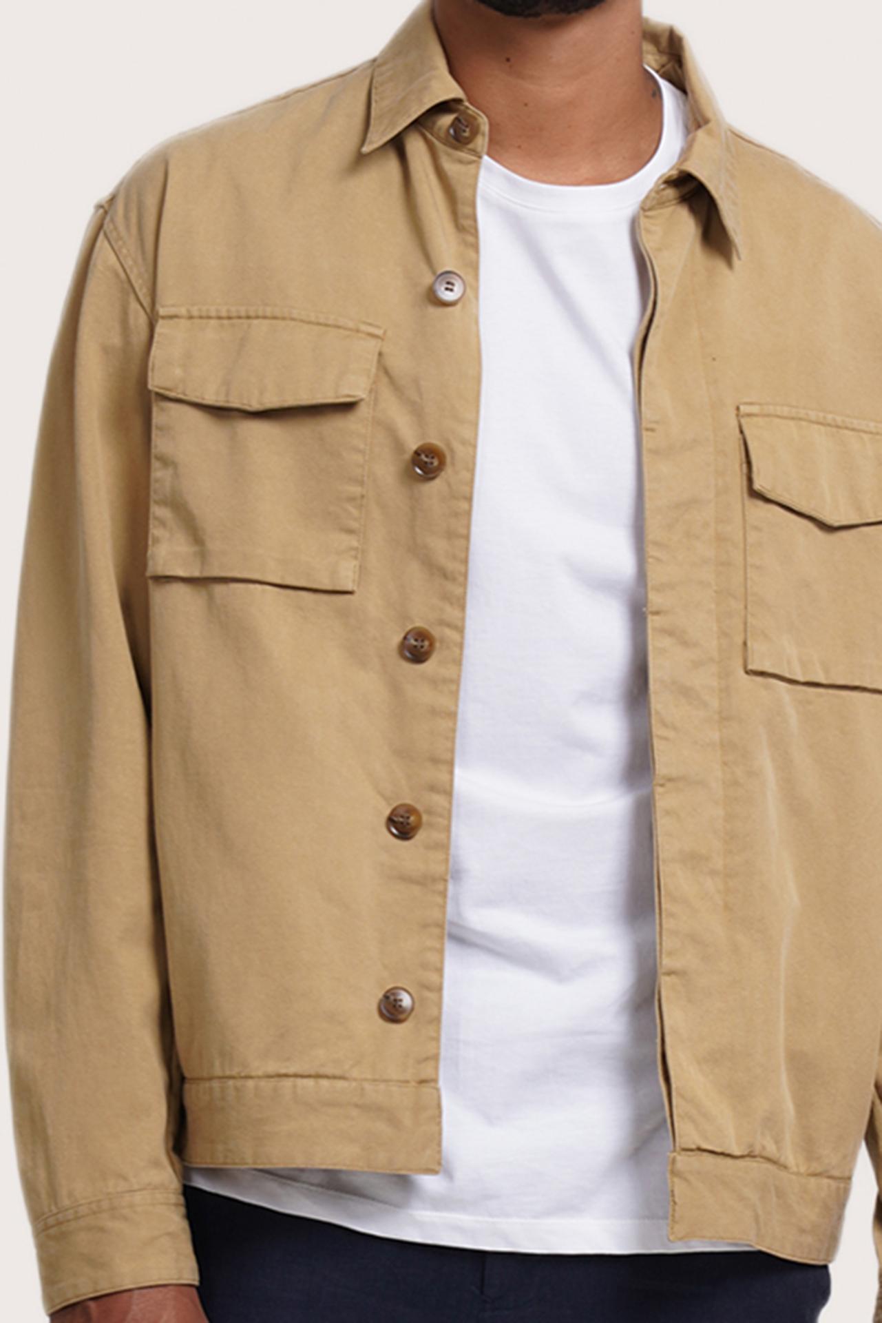 Close-up of the fabric texture and refined jacket detailing in light beige