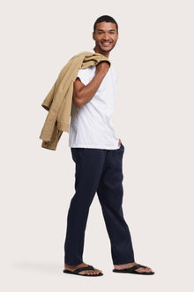 Side profile of the light beige jacket showcasing its comfortable fit and clean lines