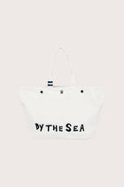 By The Sea beach bag in refined woven finish styled as an elevated resort essential, front view