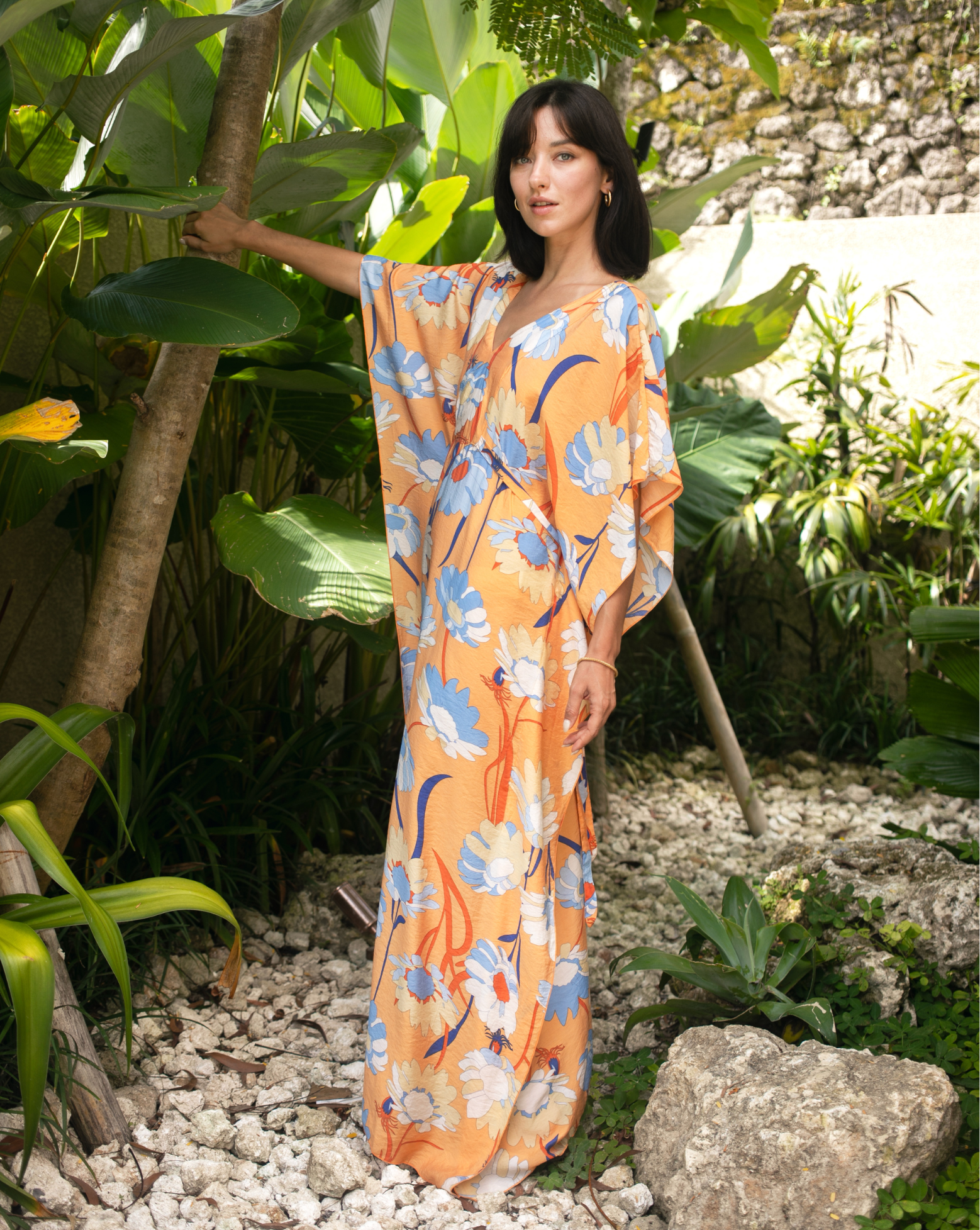 Women wearing bright orange printed kaftan in bali resort