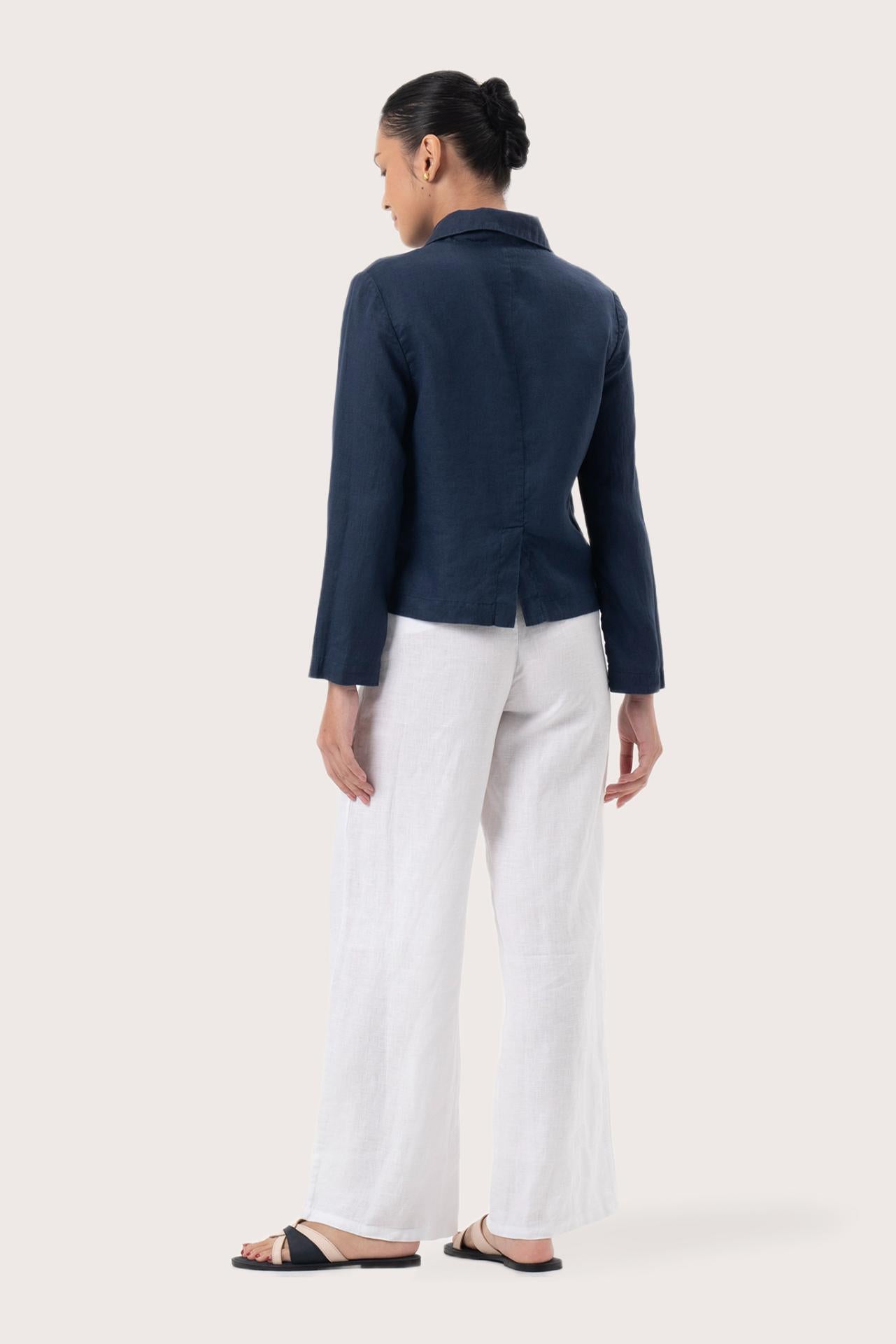 Back view of the Cala Linen Blazer Navy highlighting the garment shape and drape