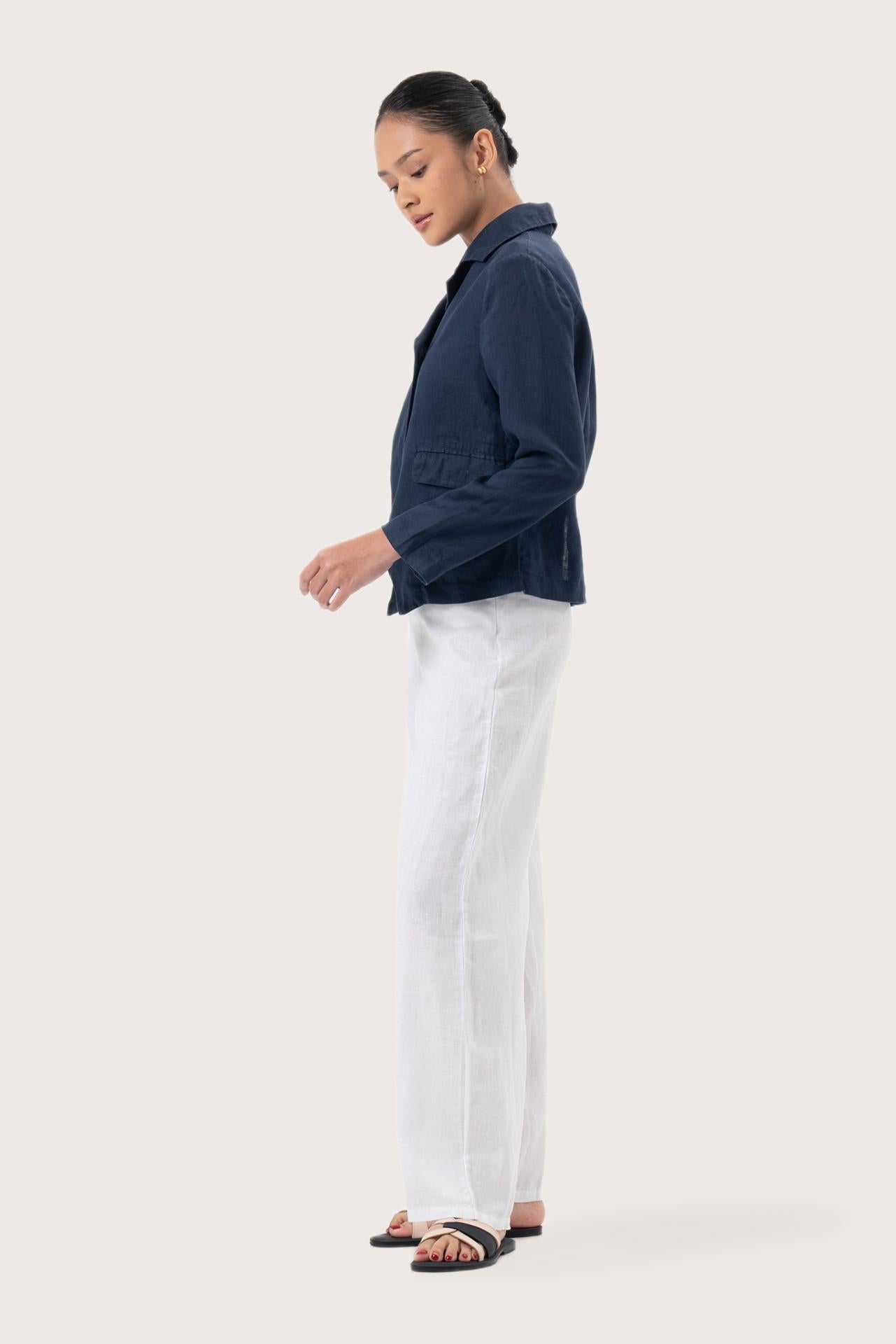 Side profile of the Cala Linen Blazer Navy showing its cut and natural movement
