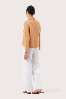 Back view of the Cala Linen Blazer Orange highlighting the garment shape and drape