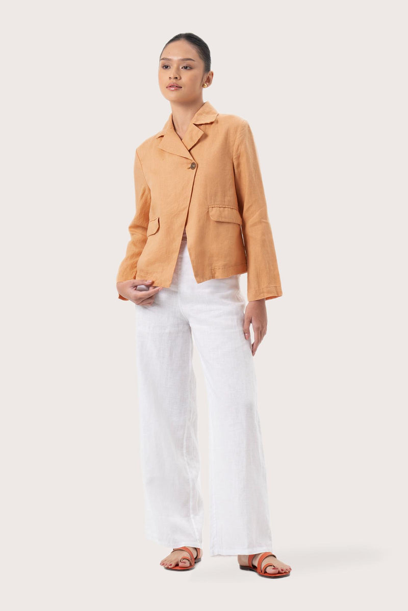 Woman wearing the Cala Linen Blazer Orange designed for effortless resortwear and tropical living by By The Sea Bali