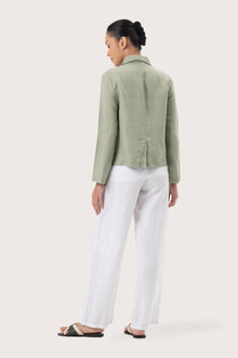 Back view of the Cala Linen Blazer Sage highlighting the garment shape and drape