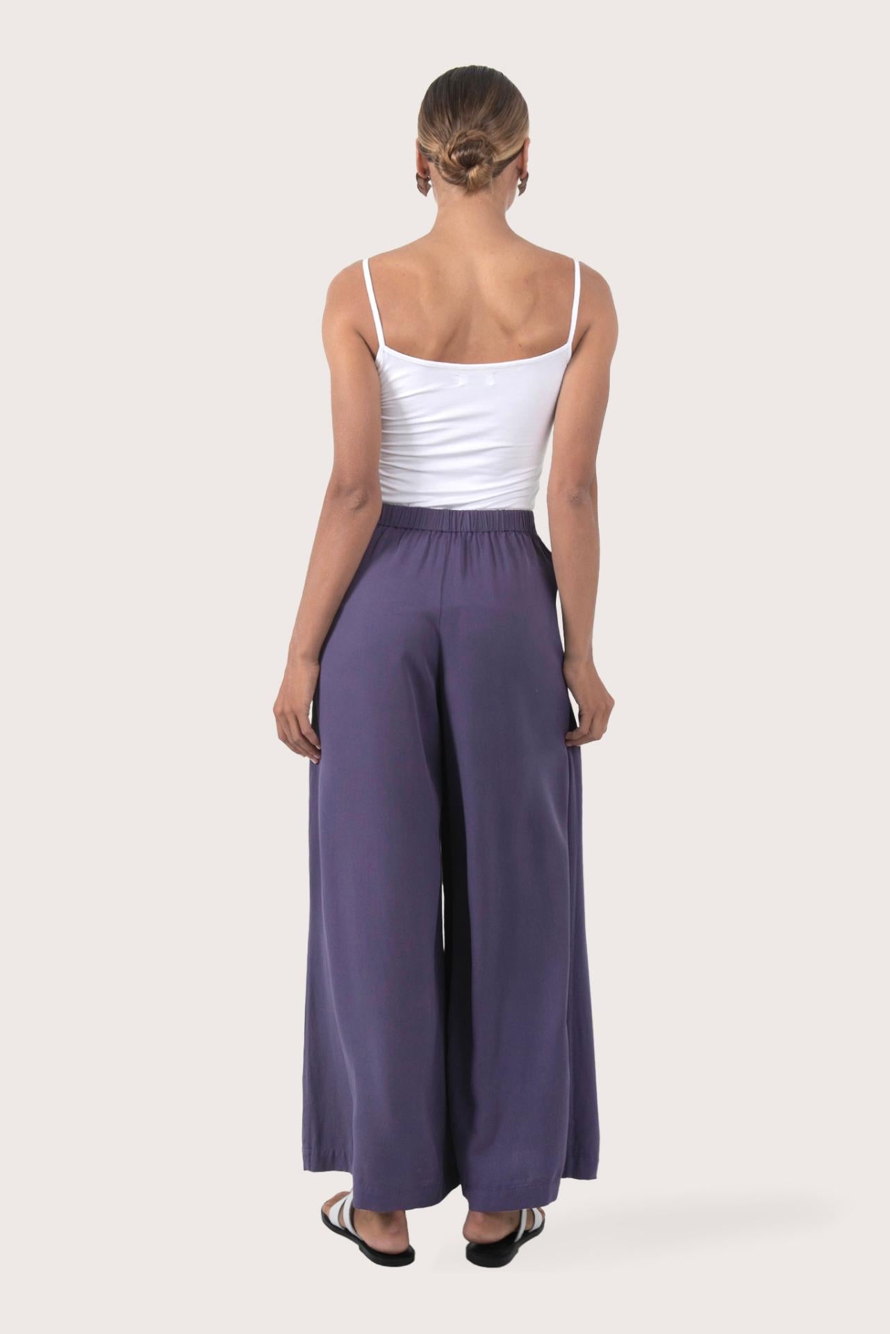 Back view of the Callie Palazzo Pants Purple highlighting the garment shape and drape.
