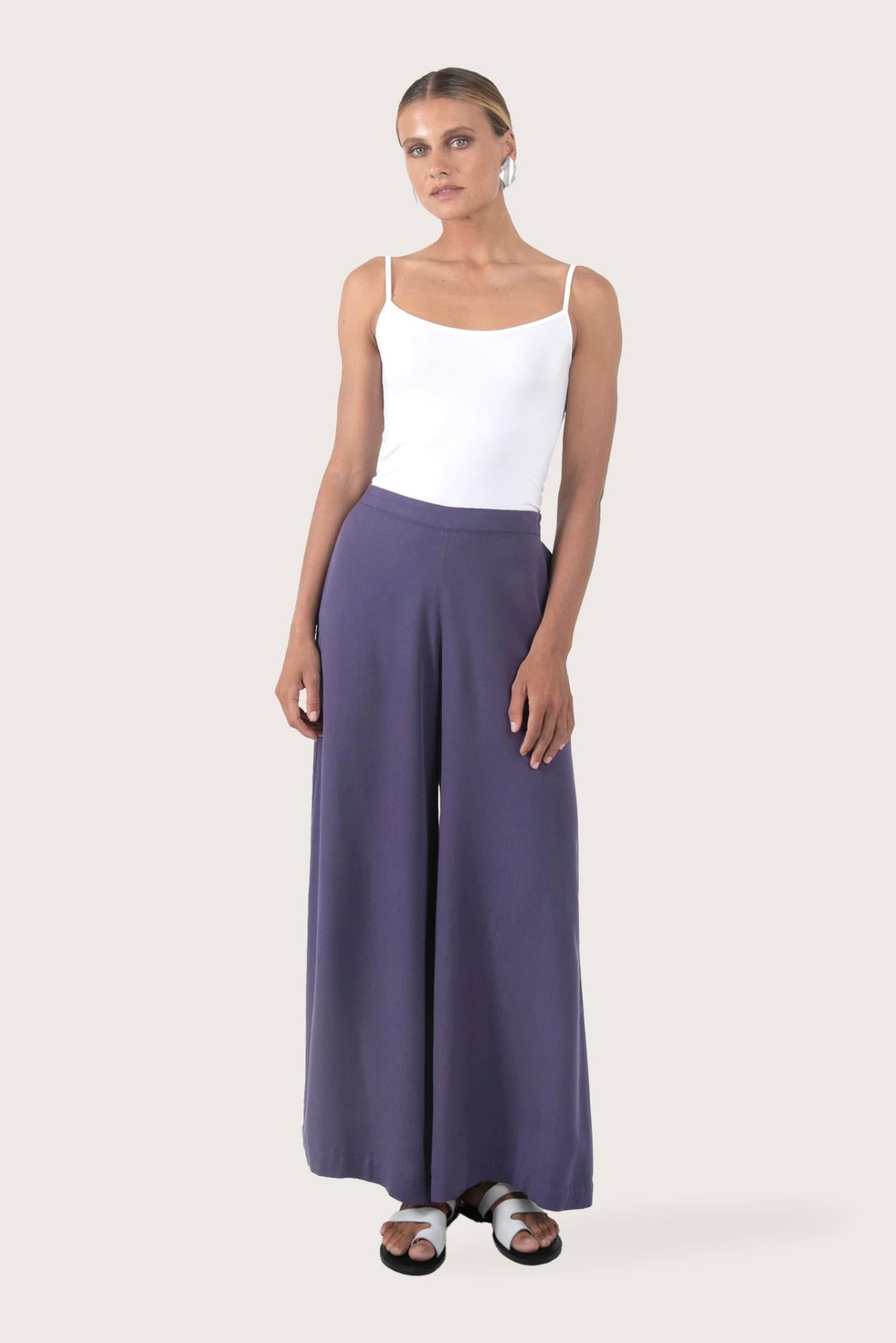 Woman wearing the Callie Palazzo Pants Purple designed for effortless resortwear and tropical living, by By The Sea Bali