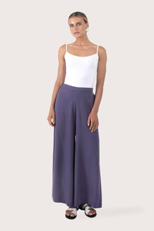 Woman wearing the Callie Palazzo Pants Purple designed for effortless resortwear and tropical living, by By The Sea Bali