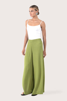 Side profile of the Callie Palazzo Pants Green showing its cut and natural movement.
